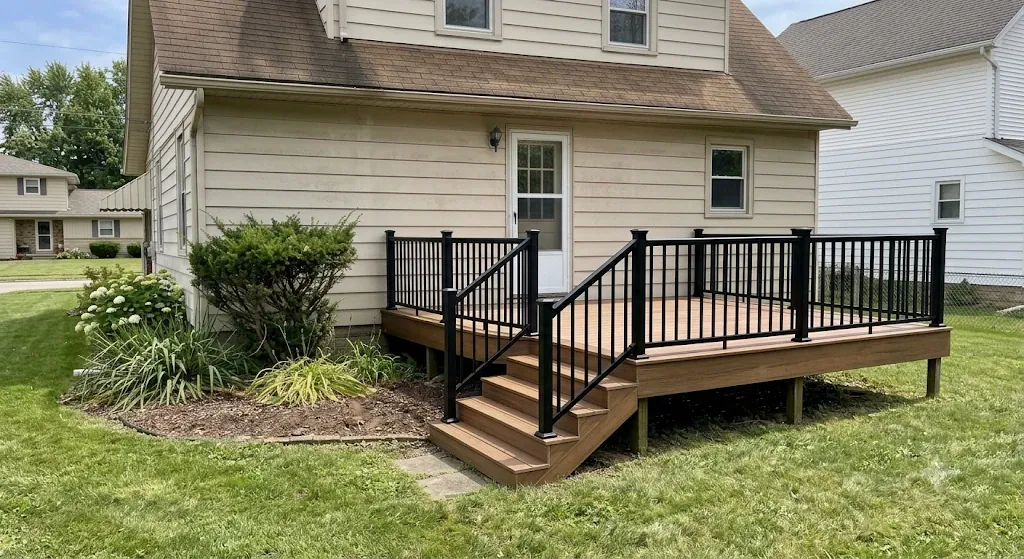 New composite deck with black aluminum railing on the same home after rebuild